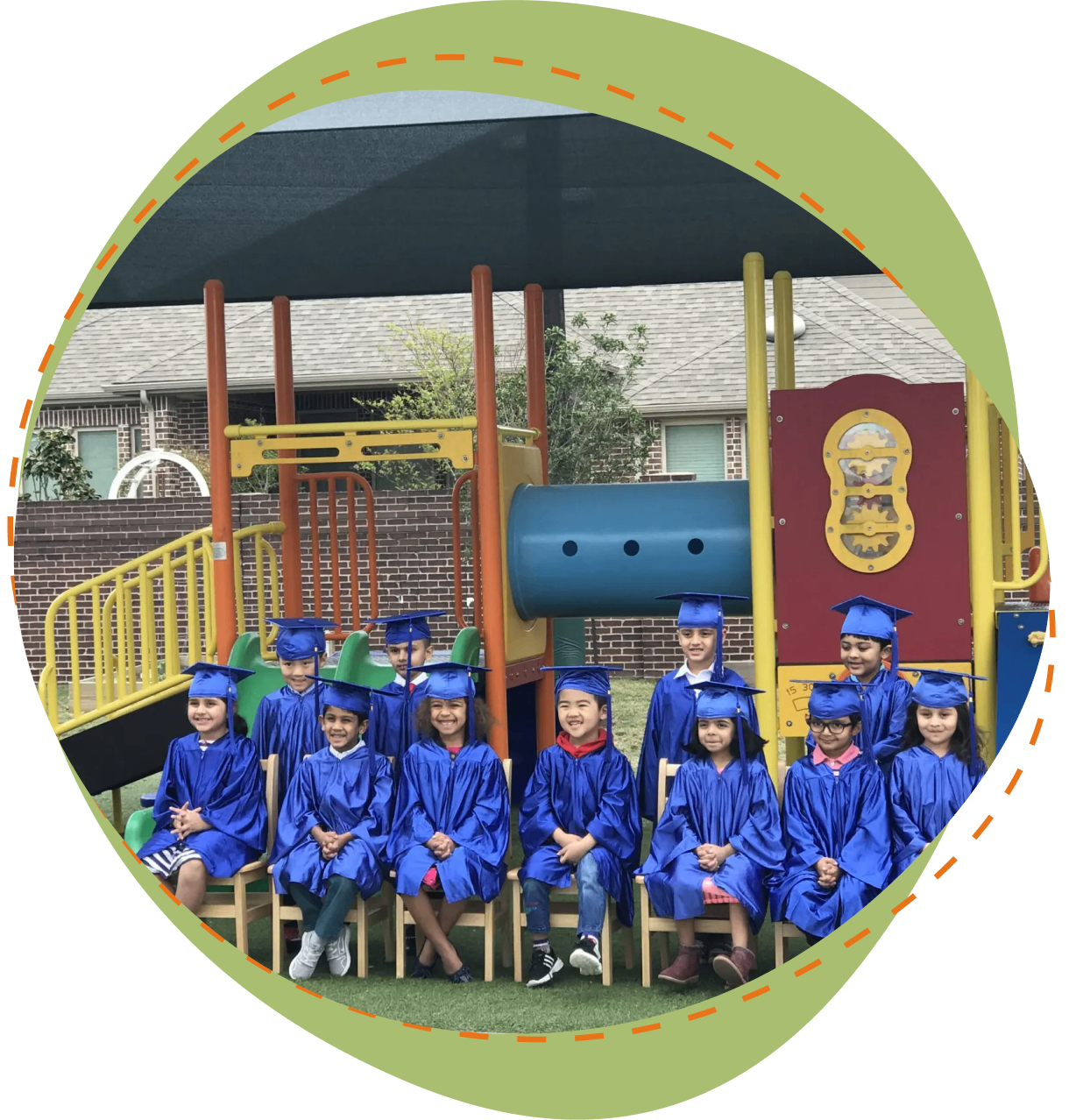 A group of children in blue caps and gowns.